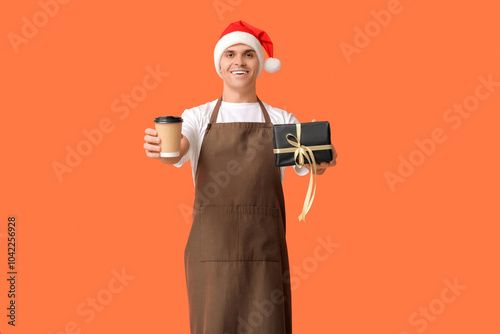 Male barista in Santa hat w...