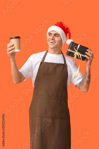 Male barista in Santa hat w...