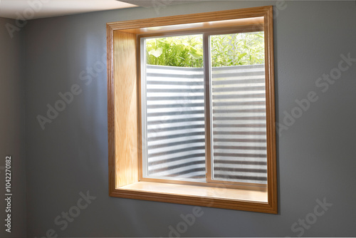 Egress window system installed in the basement. Basement bedroom with an egress window. photo