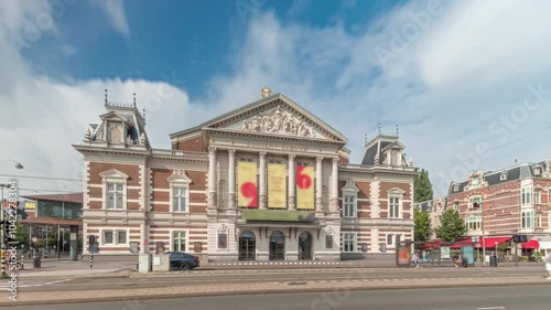 Hyperlapse of the Royal Concert Hall in Amsterdam, built in neoclassical style. Famous for its acoustics. Street traffic with tram and clouds in the sky timelapse. Amsterdam, The Netherlands photo