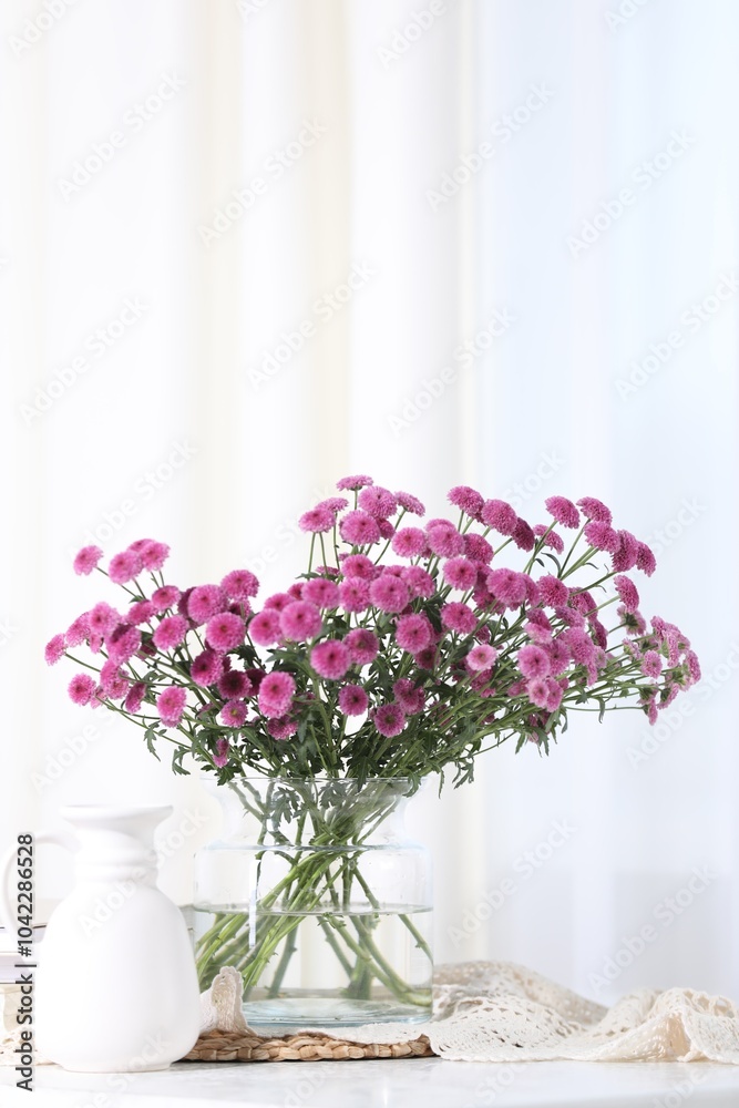 Beautiful pink flowers in vase on table indoors. Space for text Beautiful pink flowers in vase on table indoors. Space for text