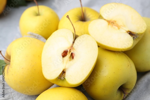 Fresh ripe yellow apples on grey table, closeup photo