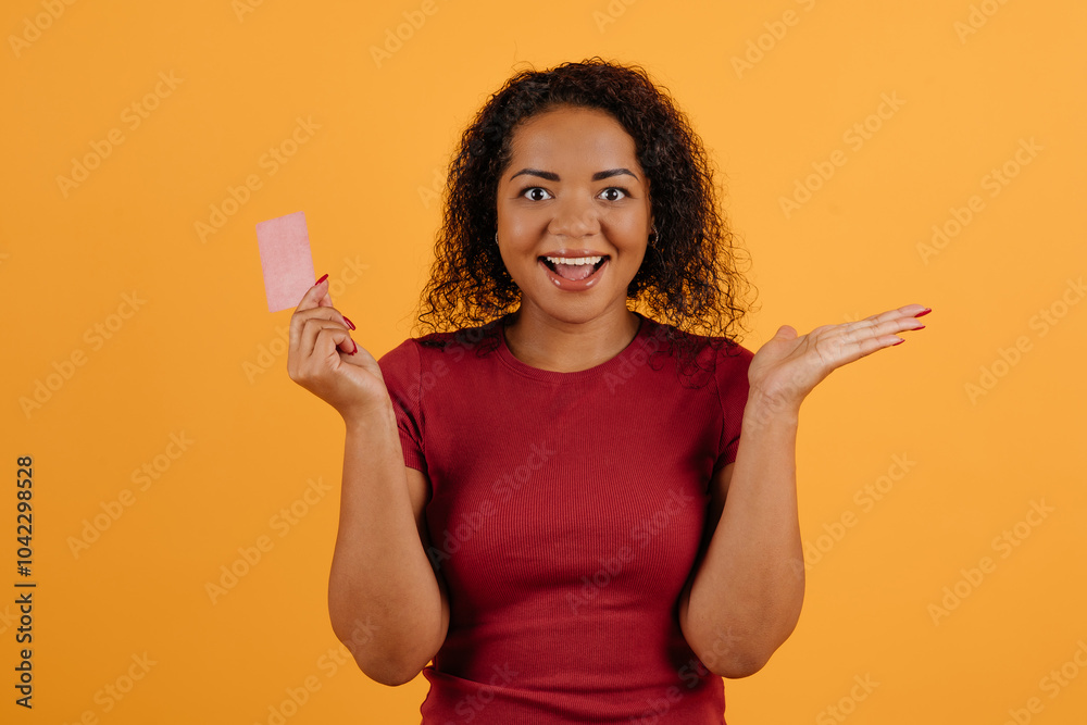 Excited Black Millennial Woman Holding Limitless Credit Card Smiling To Camera Standing Over White Background. Bank Payment Services And Banking Offers Concept. Studio Shot. High quality photo