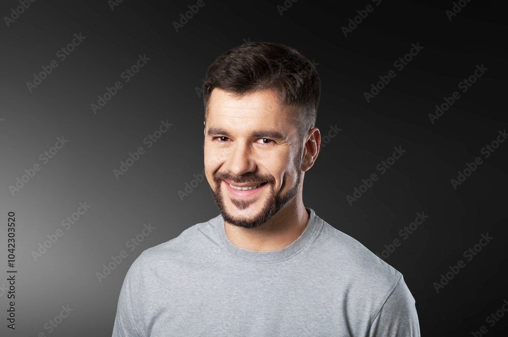 Confidence, young happy man posing in studio