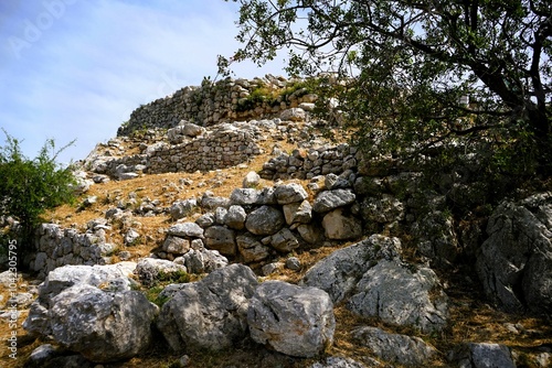 Remains of the fortification walls of Mycenae on Peloponnese in Greece. Mycenae was one of the largest citadels in Ancient Greece during the Bronze Age and played an important role in the Trojan War photo