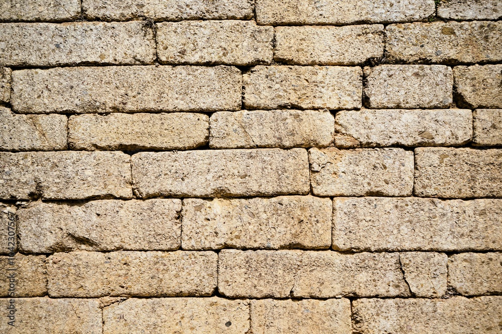 Fototapeta premium Old walls of the ancient fortress of Mycenae in Peloponnese, Greece. Mycenae was one of the largest fortresses in ancient Greece during the Bronze Age and played an important role in the Trojan War