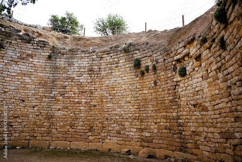 Entrance to a tholos, a tomb during the Bronze Age near the fortress of Mycenae on Peleponnes in Greece. Mycenae was a city-state in ancient Greece and played an important role in the Trojan War photo