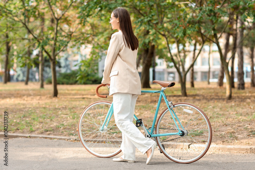 Young woman walking with bi...