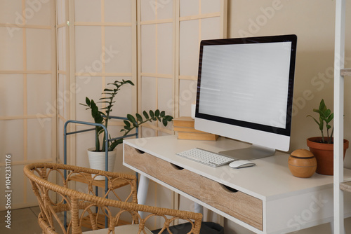 Stylish workplace with programmer desk in interior of living room