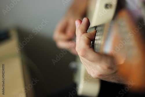 Hands playing guitar. Hands with guitar. Guitar strings close up