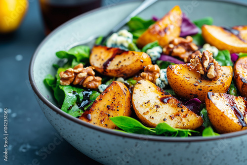 Scrumptious and nutritious salad with roasted pears, blue cheese, and walnuts topped with balsamic glaze