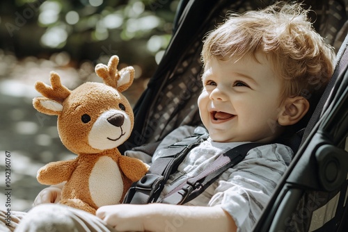 Little boy with deer plush toy, sitting in a stroller, sunny day, giggling, side angle 2 photo