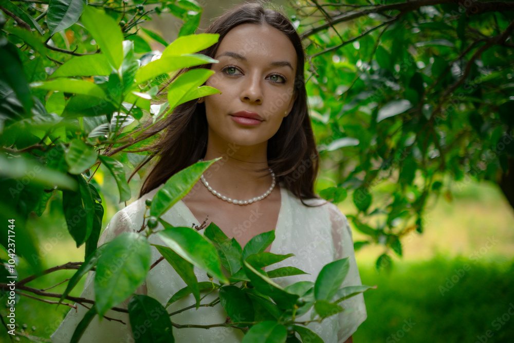 A woman peacefully walking between vibrant lemon trees, enjoying the fresh, natural surroundings, creating a calm and serene atmosphere in a garden. A woman peacefully walking between vibrant lemon trees, enjoying the fresh, natural surroundings, creating a calm and serene atmosphere in a garden.