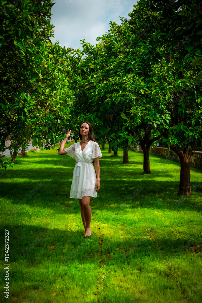 A woman peacefully walking between vibrant lemon trees, enjoying the fresh, natural surroundings, creating a calm and serene atmosphere in a garden. A woman peacefully walking between vibrant lemon trees, enjoying the fresh, natural surroundings, creating a calm and serene atmosphere in a garden.