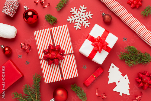 Handmade wrapped christmas gift boxes with stuff on color background, top view