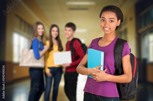 A confident student posing in university hallway,