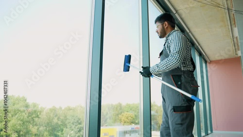 Wallpaper Mural Pakistani service worker cleaning office windows, cleaning service Torontodigital.ca