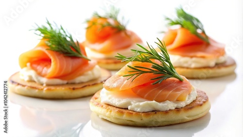 Delicious smoked salmon blinis with cream cheese and fresh dill on white background photo