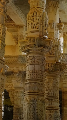 Sun and interior of beautiful Ranakpur Jain temple or Chaturmukha Dharana Vihara. Marble ancient medieval carved sculpture carvings of sacred place of jainism worship. Ranakpur, Rajasthan. India photo