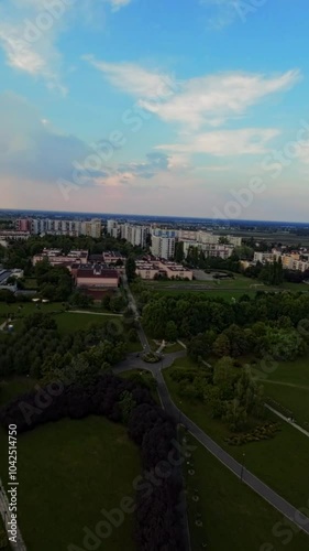 This FPV drone footage was taken in a park. The video begins with a view of a lake and some trees. The drone then flies over to a playground, where it captures footage of children playing on the