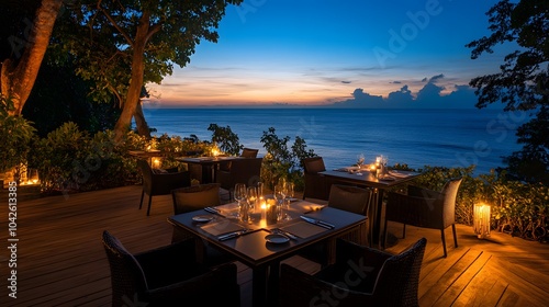 Wallpaper Mural Elegant resort with an outdoor dining area overlooking the ocean at dusk with soft candlelight and breathtaking views Torontodigital.ca