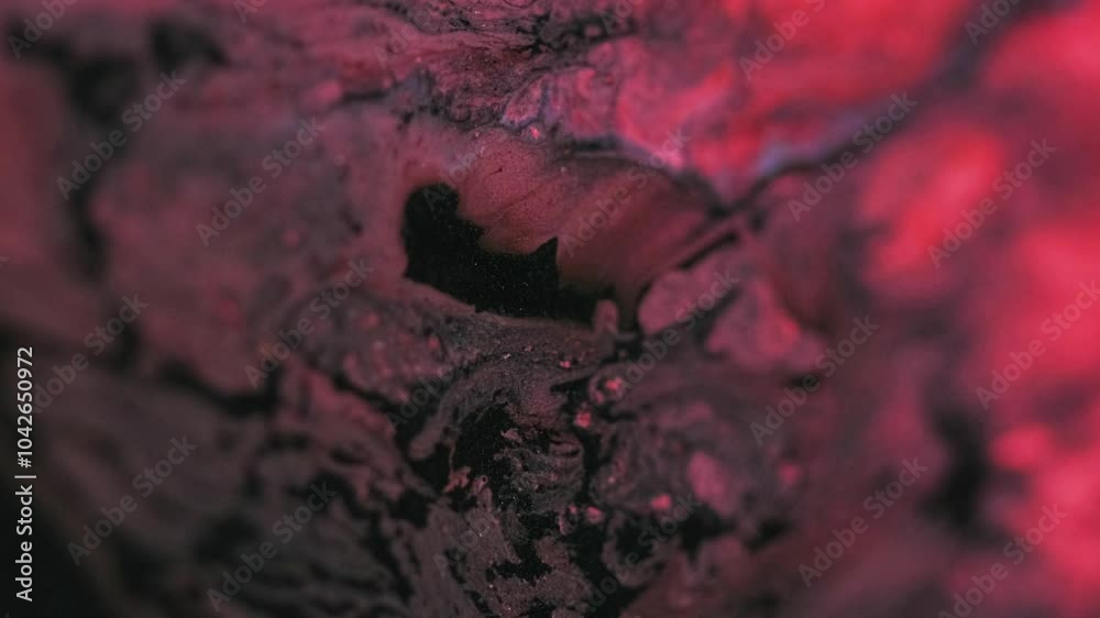 Shimmering fluid wave. Ink spill. Blur black red color sparkling glitter sand particles acrylic paint water dye pigment mix emulsion liquid flow motion abstract art background.