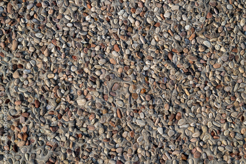 floor texture made of gravel and cement, pebble stone floor, background texture