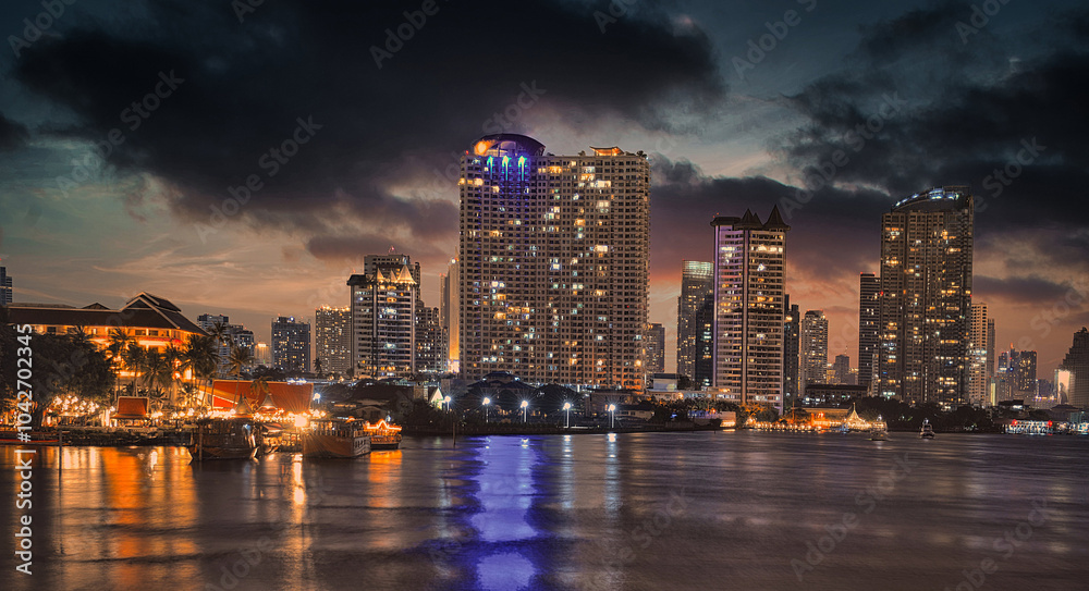 Fototapeta premium Bangkok skyline by night over the river
