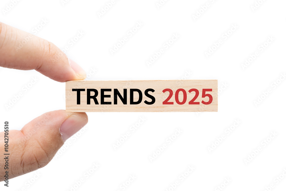 Text TRENDS 2025 wooden block on hand with Clipping path isolated on white background. marketing monitor, business planning. Text TRENDS 2025 wooden block on hand with Clipping path isolated on white background. marketing monitor, business planning.