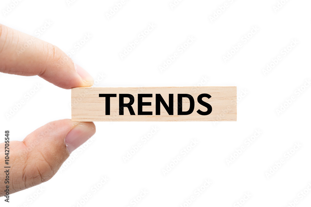 Text TRENDS wooden block on hand with Clipping path isolated on white background. marketing monitor, business planning. Text TRENDS wooden block on hand with Clipping path isolated on white background. marketing monitor, business planning.