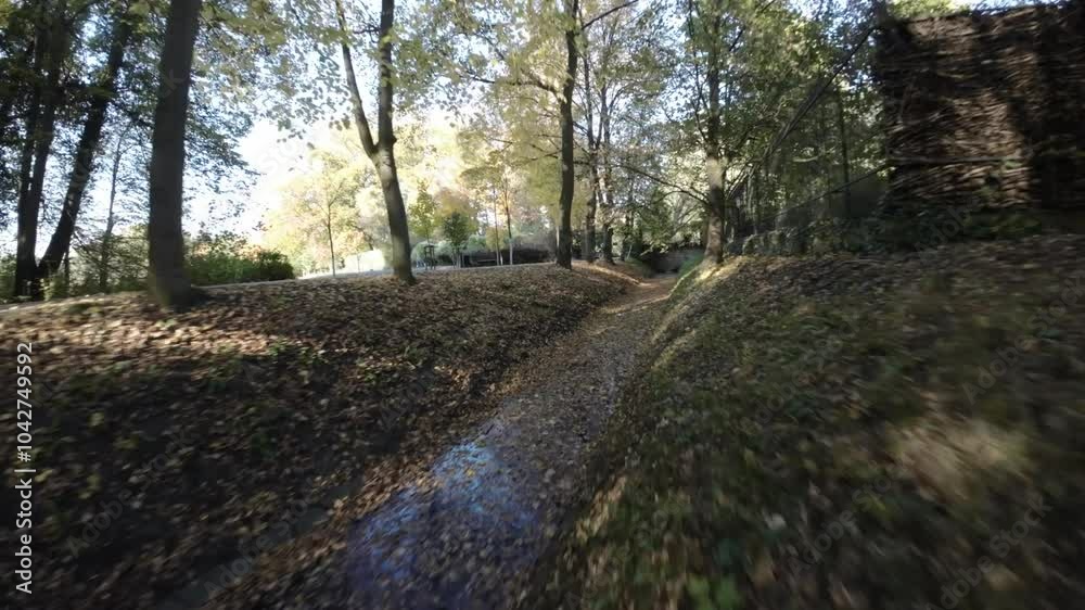 A first-person view FPV flight through a park in autumn. The video is taken from the perspective of a drone flying through the park, and it provides a unique view of the fall foliage. The drone flies A first-person view FPV flight through a park in autumn. The video is taken from the perspective of a drone flying through the park, and it provides a unique view of the fall foliage. The drone flies