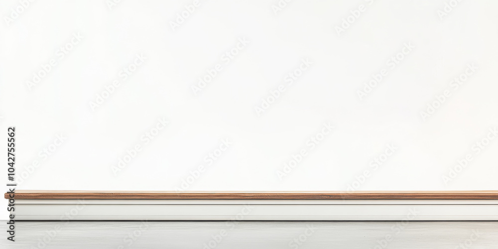 Simple white wall with wooden skirting in a minimalist interior setting during daytime Simple white wall with wooden skirting in a minimalist interior setting during daytime
