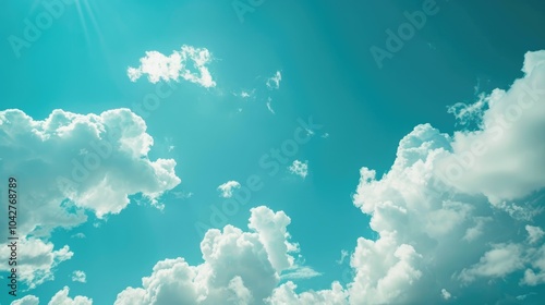 A bright blue sky with fluffy white clouds.