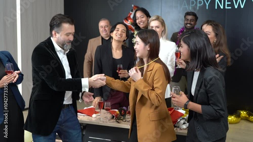 group of diversity business people celebrate in corporate new year and Christmas party together in office . manager giving best performance gift to a woman colleague in meeting party