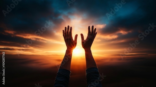 The praying man raises his hands to sunshine or sunset photo