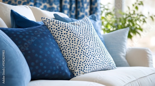 Close-up of Blue Dotted Decorative Pillows with Plant Accent photo