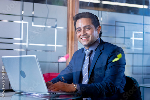 Photography Successful businessman in modern office working on laptop