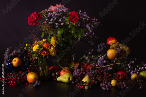 Still life of fruits and berries on black background, autumn har photo