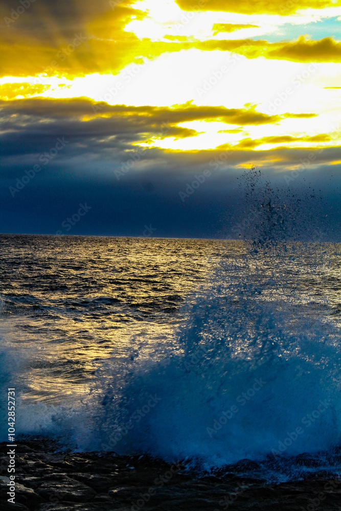 Fototapeta premium Oceanic Symphony. The ocean's power is on full display in this stunning image. The crashing wave, the aquamarine water, and the spray combine to create a symphony of nature's beauty.