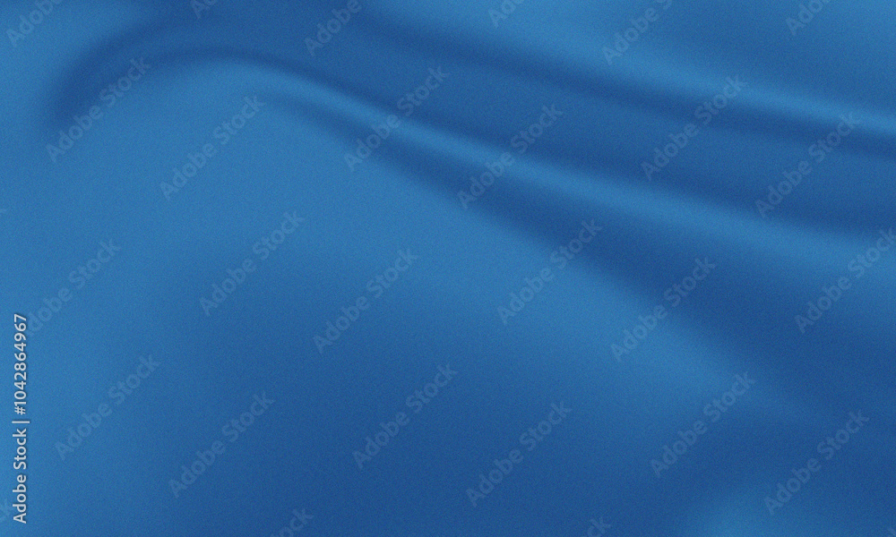 Obraz premium This versatile stock image features a smooth, blue fabric with elegant folds. It evokes feelings of luxury, comfort, and style.