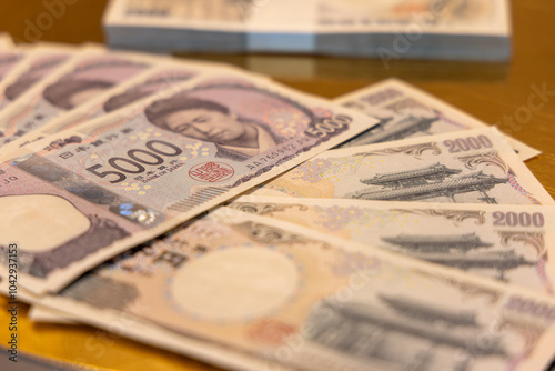 Selective focus on 5000 yen banknote with soft blur on 2000 yen bills in the background showcasing intricate currency details and financial representation photo