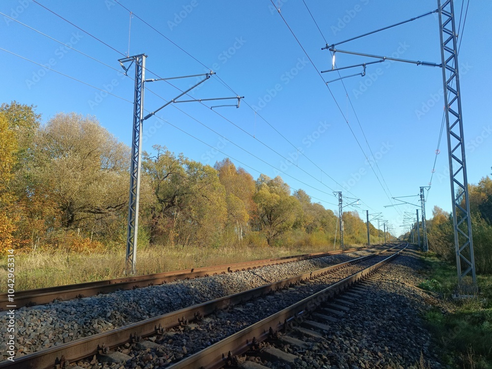 Two way railroad tracks in countryside. Two railway tracks. Sunny day. Countryside. Fields and trees. Two way railroad tracks in countryside. Two railway tracks. Sunny day. Countryside. Fields and trees.