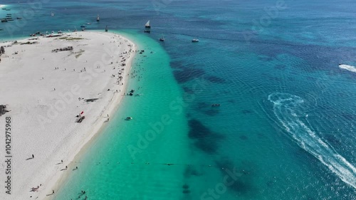 Aerial video footage of area around the historic Stone Town, the oldest part of Zanzibar Town on Unjuja island, Tanzania, starting at Shangani Beach, flying along historic buildings and landmarks  photo