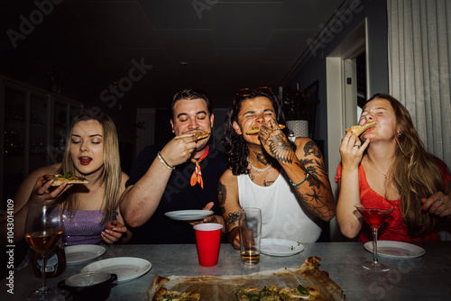 Friends eating pizza during party at home