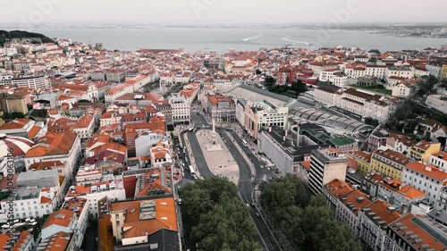 Drone captures a panoramic view of Lisbon’s city center and flies toward Monumento dos Restauradores, showcasing the historic architecture and vibrant urban landscape.