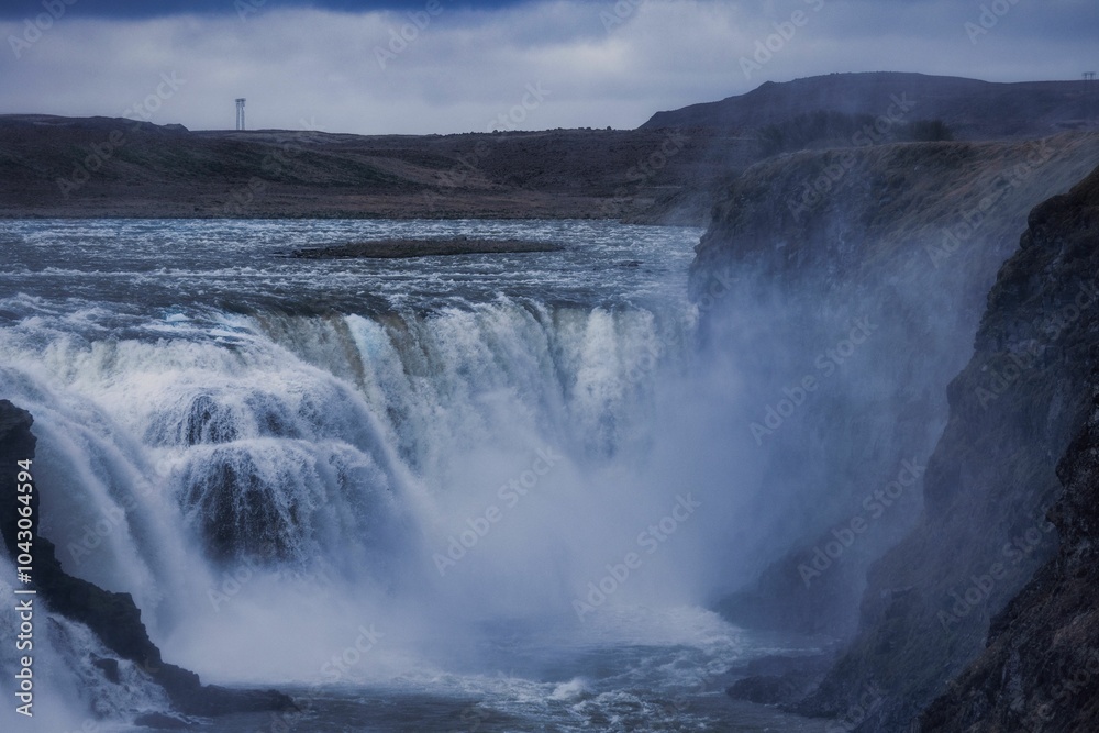 Fototapeta premium Majestic waterfall under a moody sky.