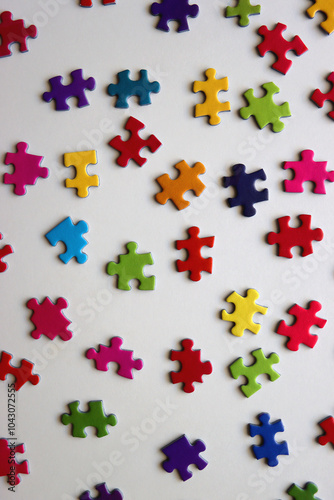 Colorful jigsaw puzzle pieces on white background. Flat lay.