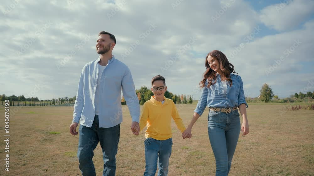 Caucasian family trip parents child walking together wheat field park smiling happy mother woman female holding hands father male man talk little kid boy son enjoy active rest friendly discuss holiday Caucasian family trip parents child walking together wheat field park smiling happy mother woman female holding hands father male man talk little kid boy son enjoy active rest friendly discuss holiday