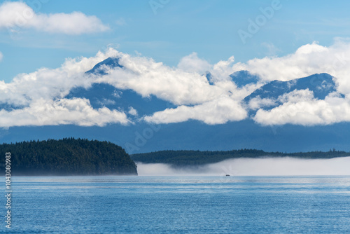 Whale watching boat silhouette in mist and fog, Telegraph Cove, Vancouver Island, British Columbia, Canada.