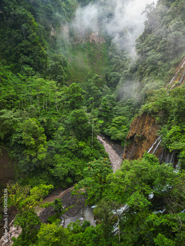 Aerial view of a magnificent waterfall in a lush forest